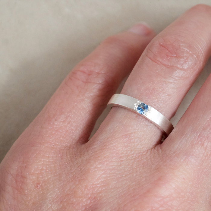 Cornflower blue sapphire argentium silver ring on the hand from Natalie Vernazza Jewellery.