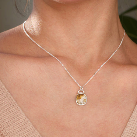 Dendritic agate pendant on a model